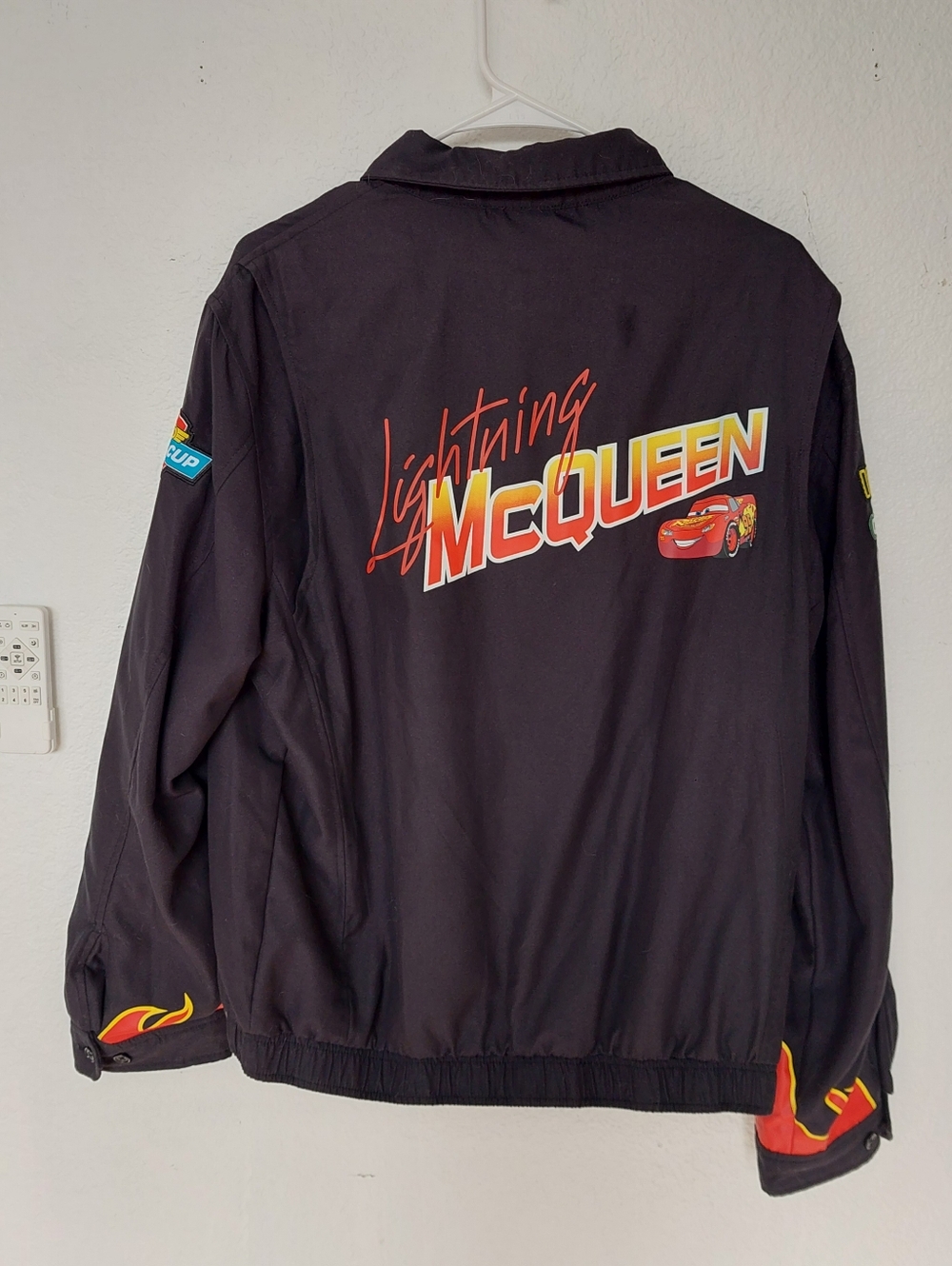Disney Pixar Cars racing jacket is inspired by Lightning McQueen, featuring Rust
